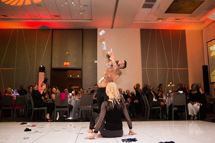 Dan Starostecki throws money in the air to end his routine.