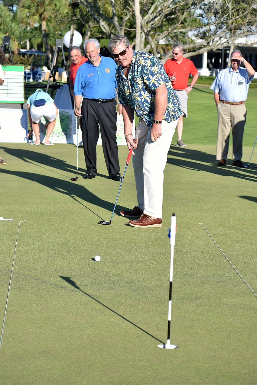 Longboat Key Police Chief Pete Cumming watches the ball roll toward the hole after his putt.