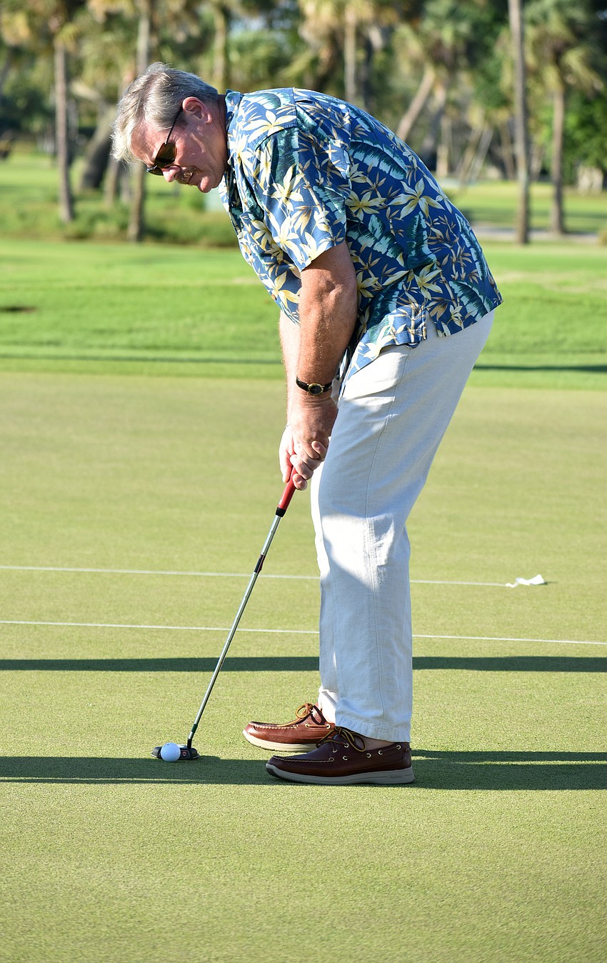 Longboat Key Police Chief Pete Cumming gets ready to putt.