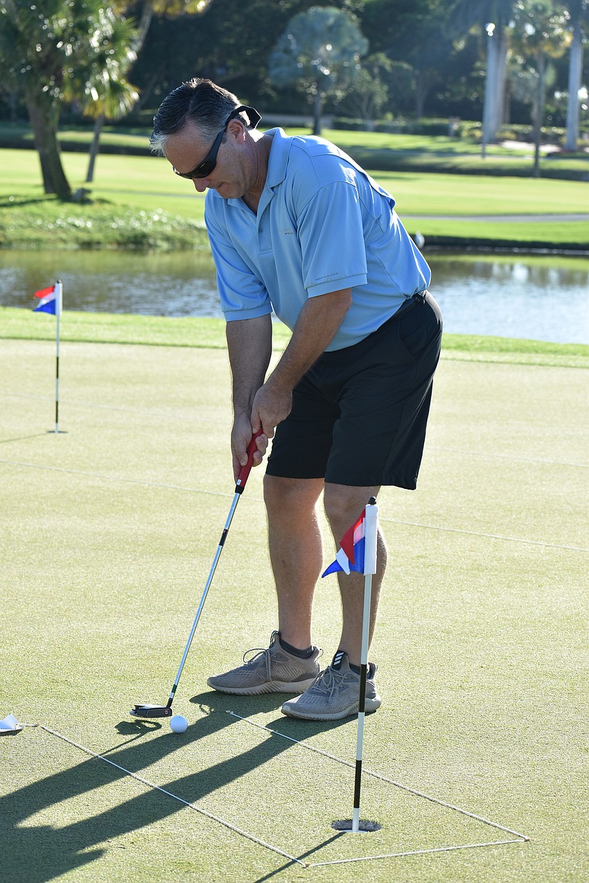 Longboat Key Fire Rescue Chief Paul Dezzi takes his turn at the putting challenge.