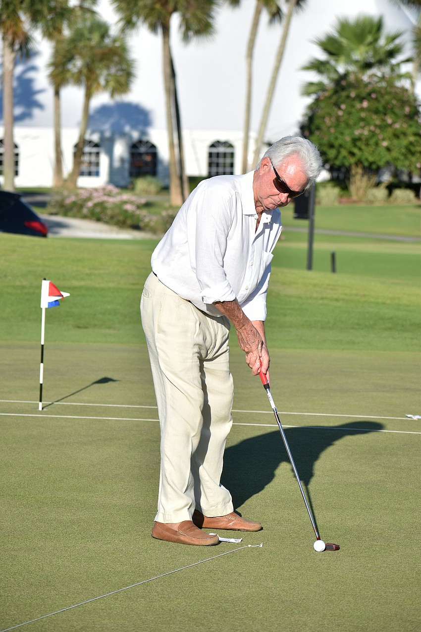 Commissioner Jim Brown eyes the hole before he putts.
