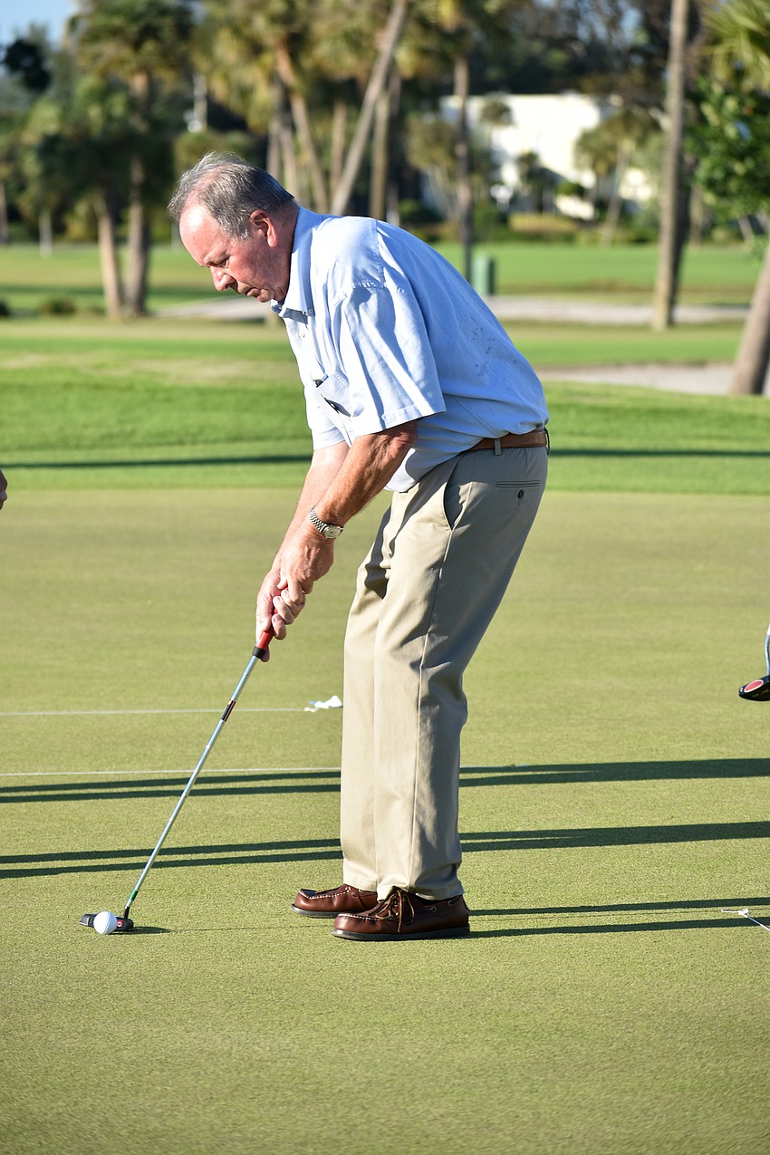 Commissioner Randy Clair gets ready to putt.