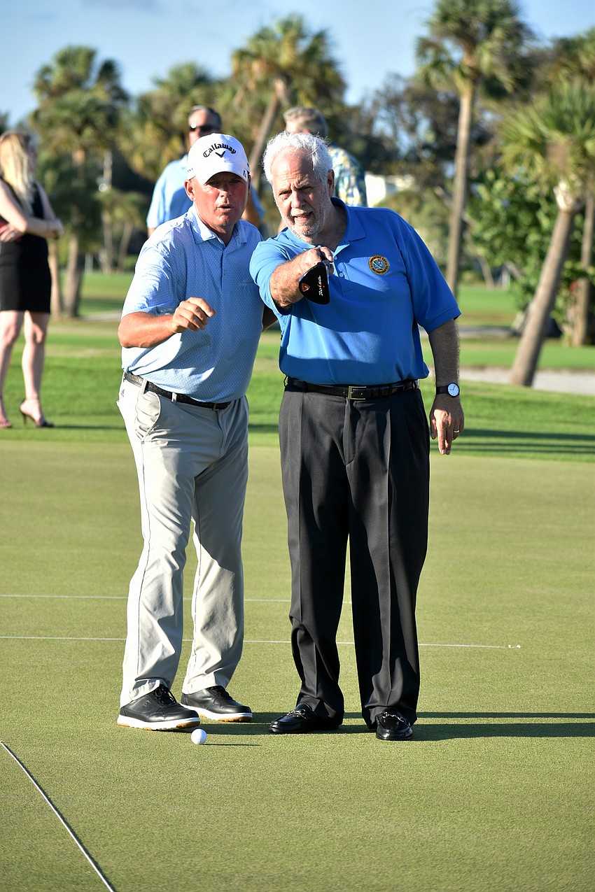 Longboat Key Club Director of Golf Terry O’Hara gives Commissioner Irwin Pastor advice on the final hole.