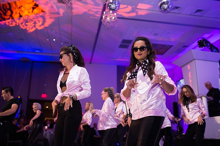 Donna Koffman and Umbreen Khalidi-Majeed dance with Elisabeth Waters.