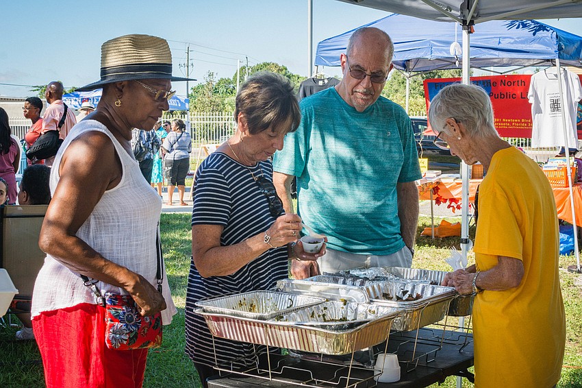 Attendees sample various collard green dishes.