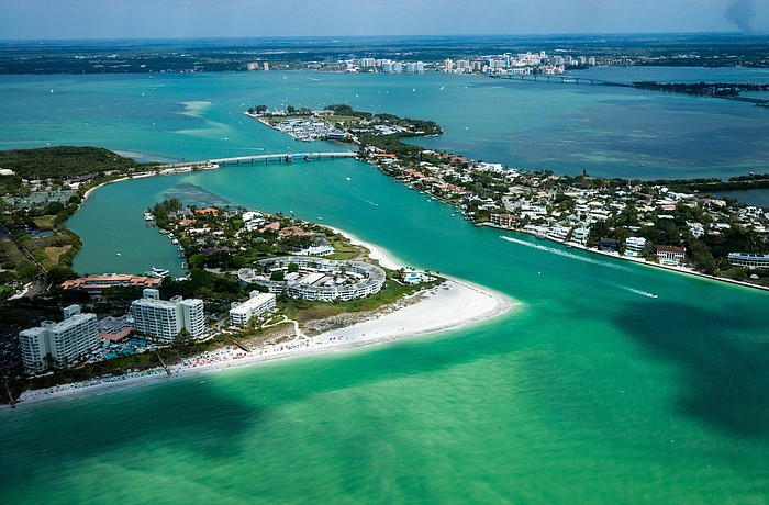 New Pass will be dredged later this year, but the U.S. Coast Guard is reserving judgment on whether the project will allow resetting of the boat channel markers.
