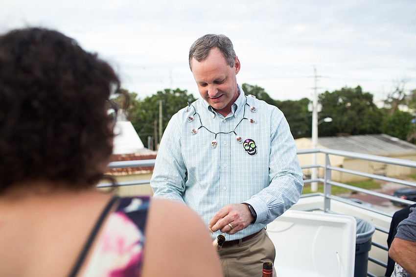 William Russell serves drinks to guests.