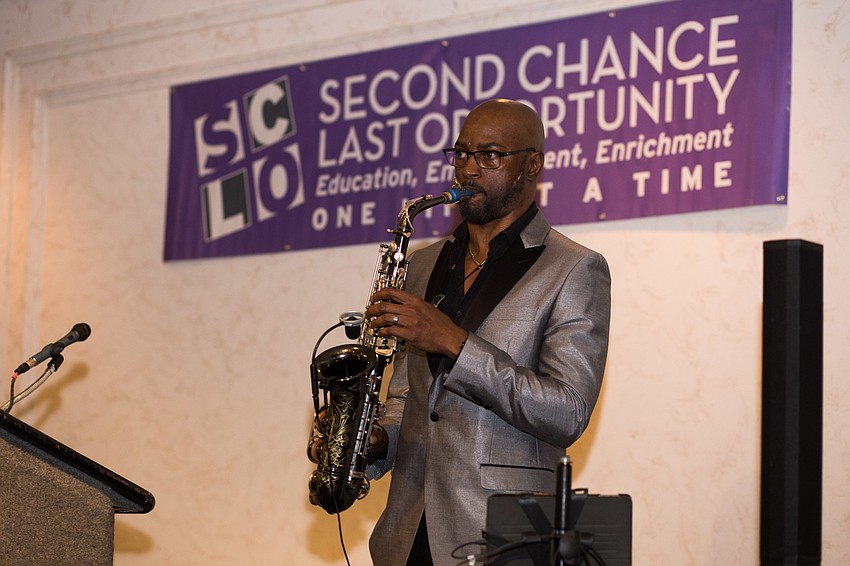 Marlon Boone gave a brief musical presentation while guests enjoyed their lunch.