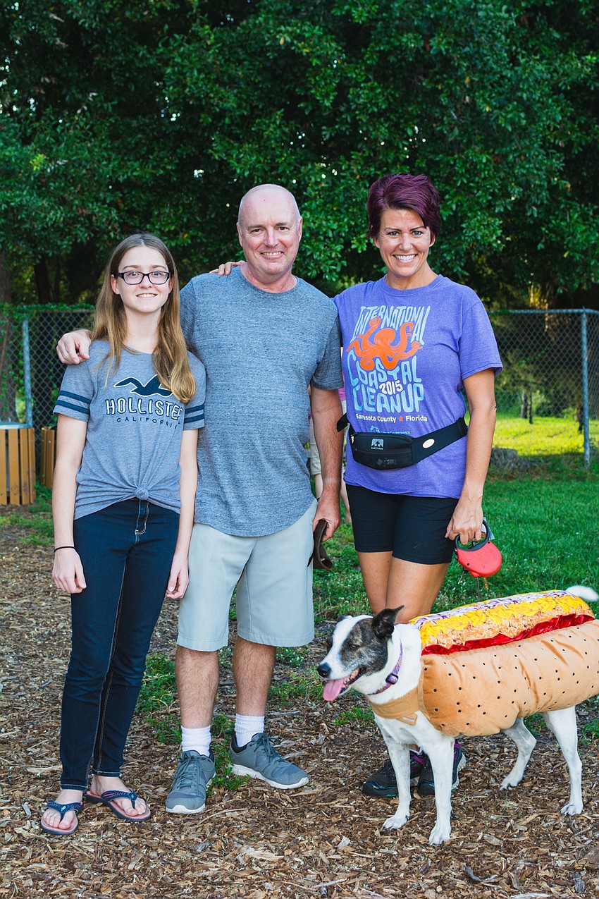 Alana, Alan and Carlann Evans with their dog Abby.