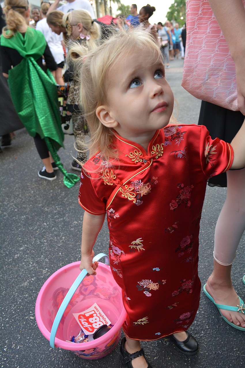 Two-year-old Jordan Hinton, of Lakewood Ranch, collects candy with her cousin, 10-year-old Ella Mattes, not pictured.