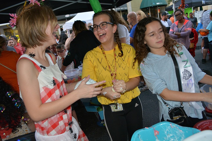 East County youth Mimi Zimmerman, Sydney Oostendorp and Gianna Heinemann make take-home slime for the masses using glue, water, borax and food coloring.
