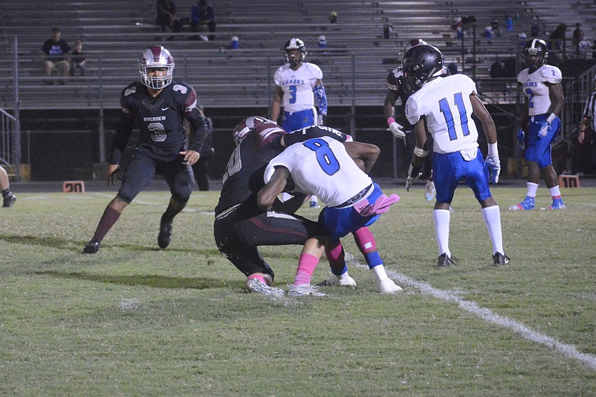 Junior DB Hal Bloom takes down a Shark in the backfield.