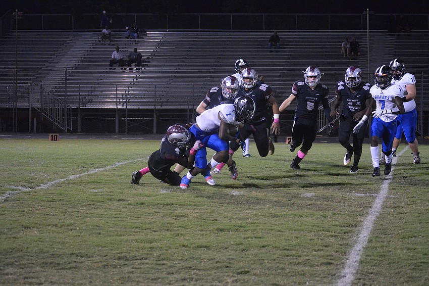 Junior DL Jayden Cray (4) sacks a Sharks QB.