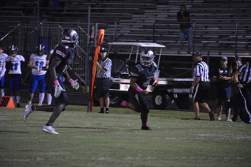 Senior RB Ali Boyce (22) looks back at Sharks defenders trailing him before waltzing into the end zone.
