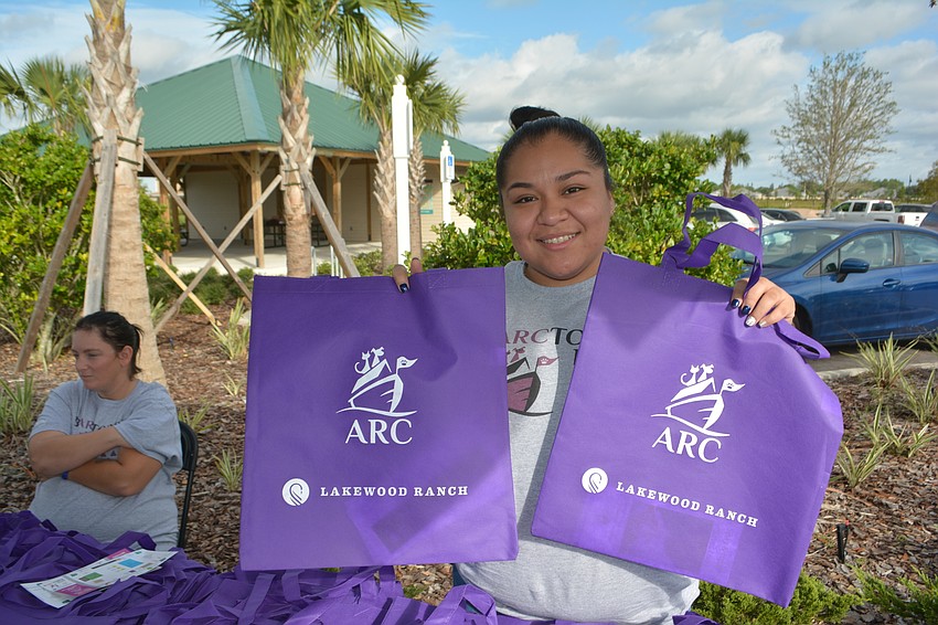 Animal Rescue Coalition volunteer Regina Mantero handed out gift bags at the entrance to Barctober Fest.