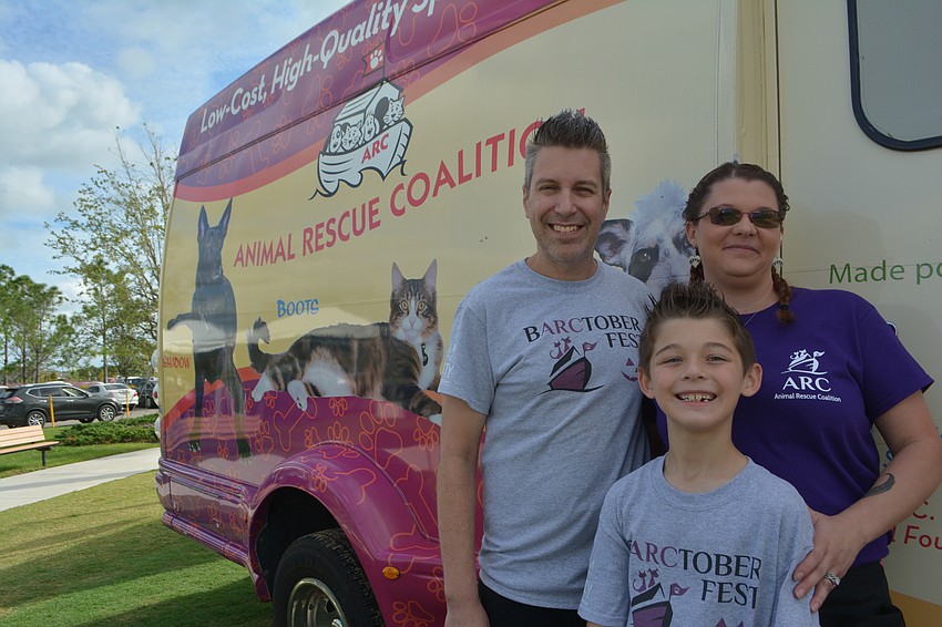 ARC volunteers Chris and Whitney Jones worked with their son, Jonah, in front of the spay and neuter transport truck.