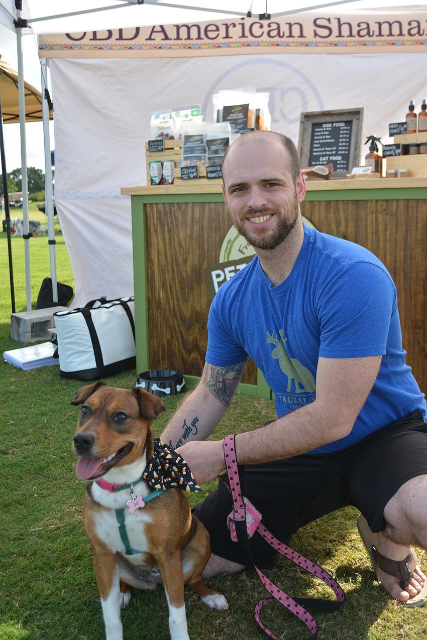 Chris McNamara kneels next to Kate, a 6-year-old Australia cattle dog/boxer mix. McNamara is with GreyZK USA Worldwide.