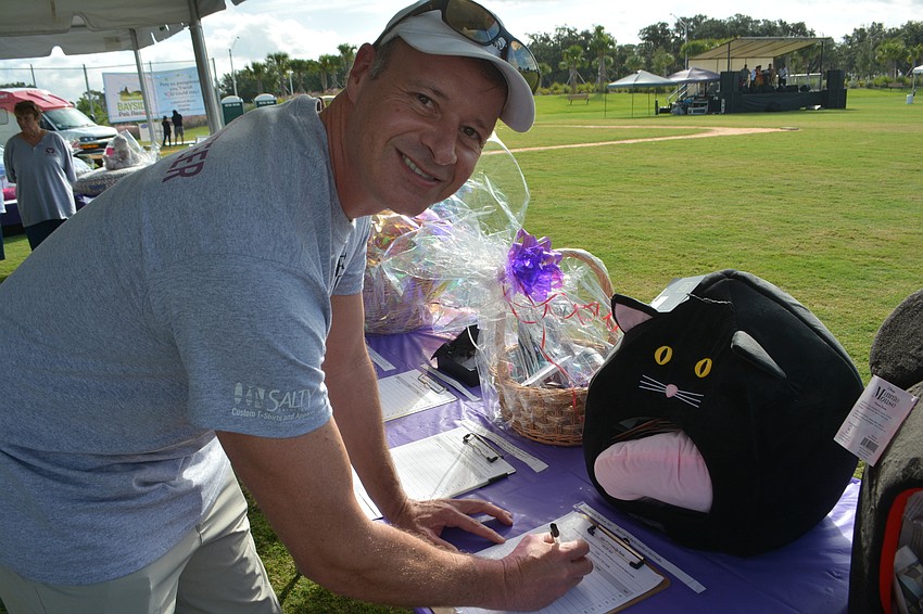 Animal Rescue Coalition board member Scott Bush submits a bid for the silent auction.