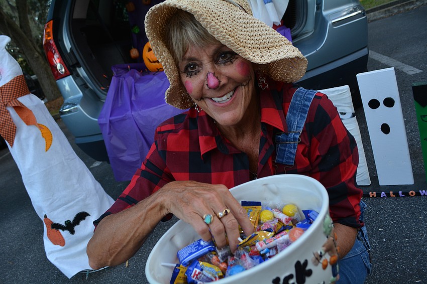 Scarecrow Shari Medley passes out candy. She's been a church member for 13 years.