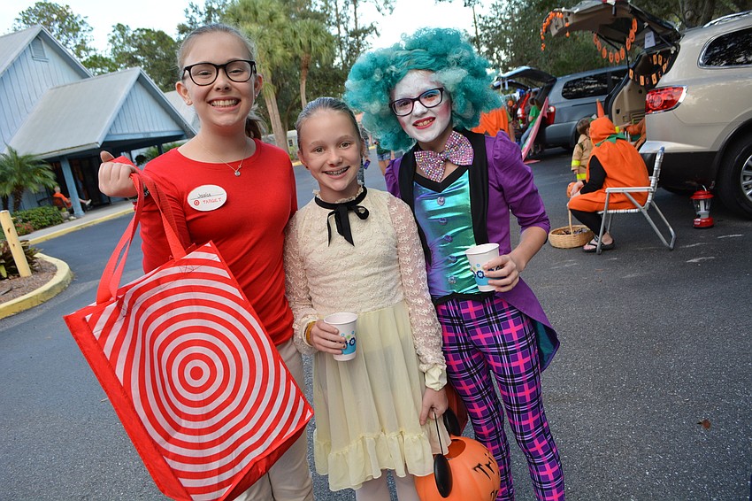 Anja and Emma Schwarzbauer collect candy with friend Katie Powers.
