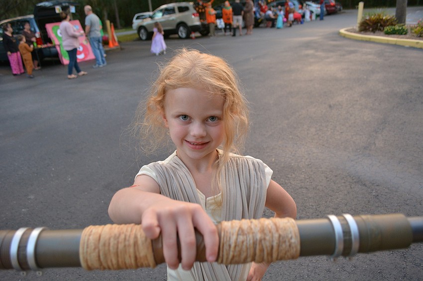 Six-year-old Anna Mylett loves her Star Wars costume. As Rey, she had both a stick and lightsaber.