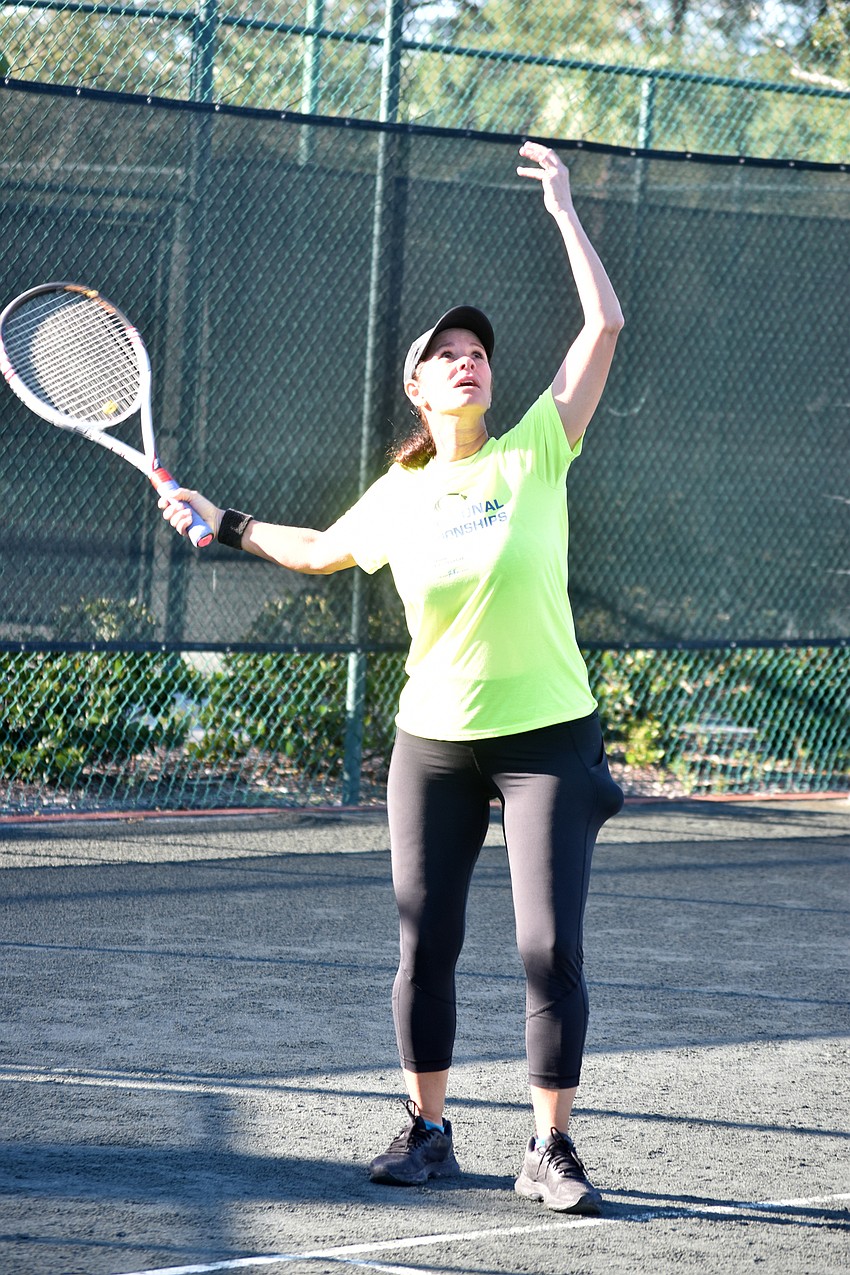 Jenn Bright serves the ball during a final match.