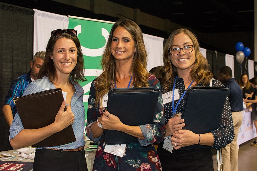 Gina Santoianni of Mote with State College of Florida graphic design students Tara Khleif and Megan Yost