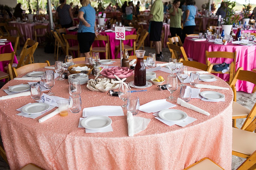 The tables were set up underneath a large tent in the sand.