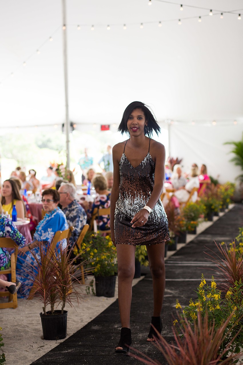 Samantha Gholar walks the runway in a Scout and Molly's sequin dress.