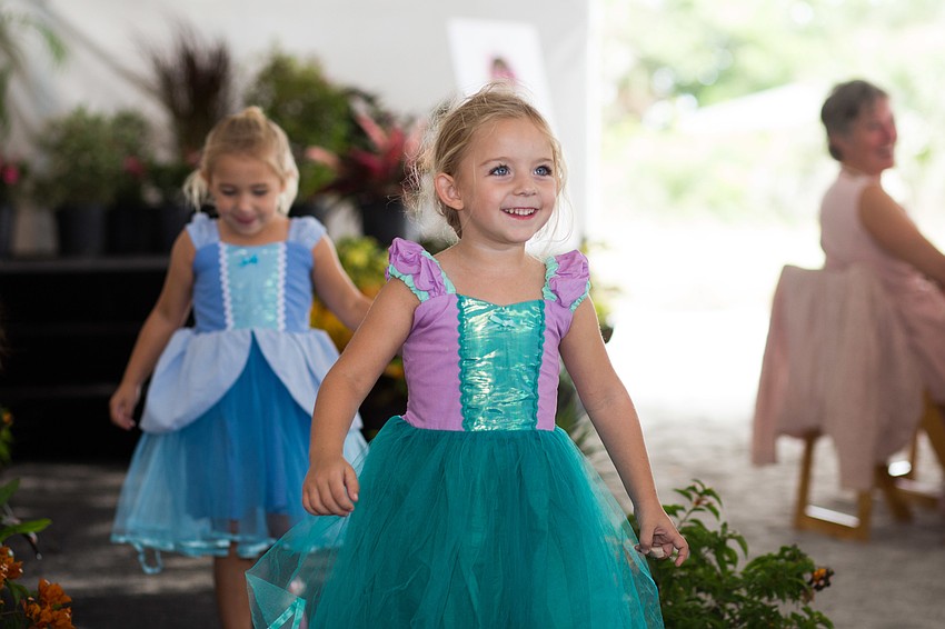 Cliff Roles' granddaughters, Azzi and Emmy, run down the runway in their princess dresses from Buttons and Bows.