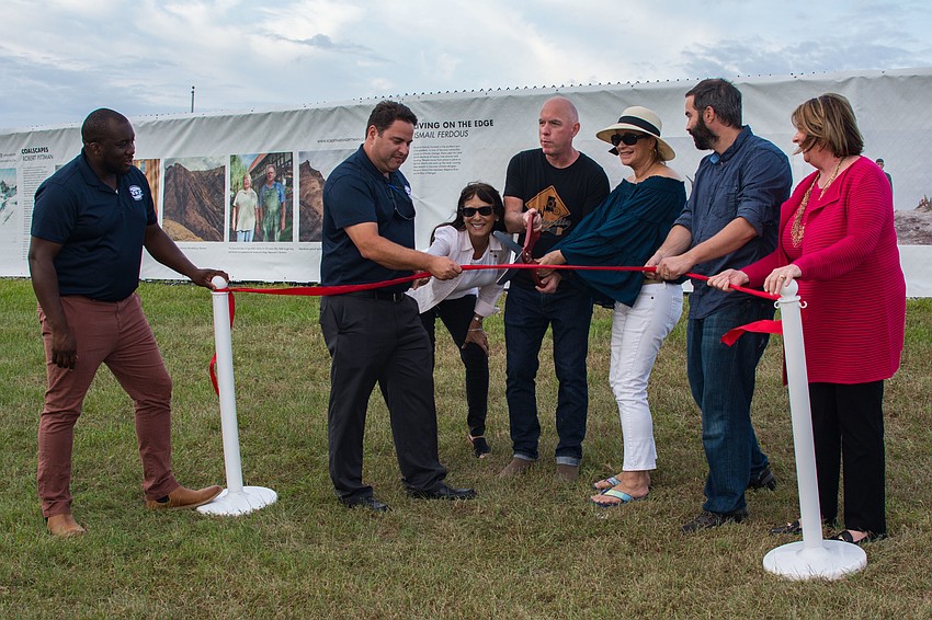 Michael Washington, Stephen Rodriguez, Barbara Strauss, Dave Shelley, Laurie Feder,  Sam Barzilay and Virginia Haley participate in the ribbon-cutting.