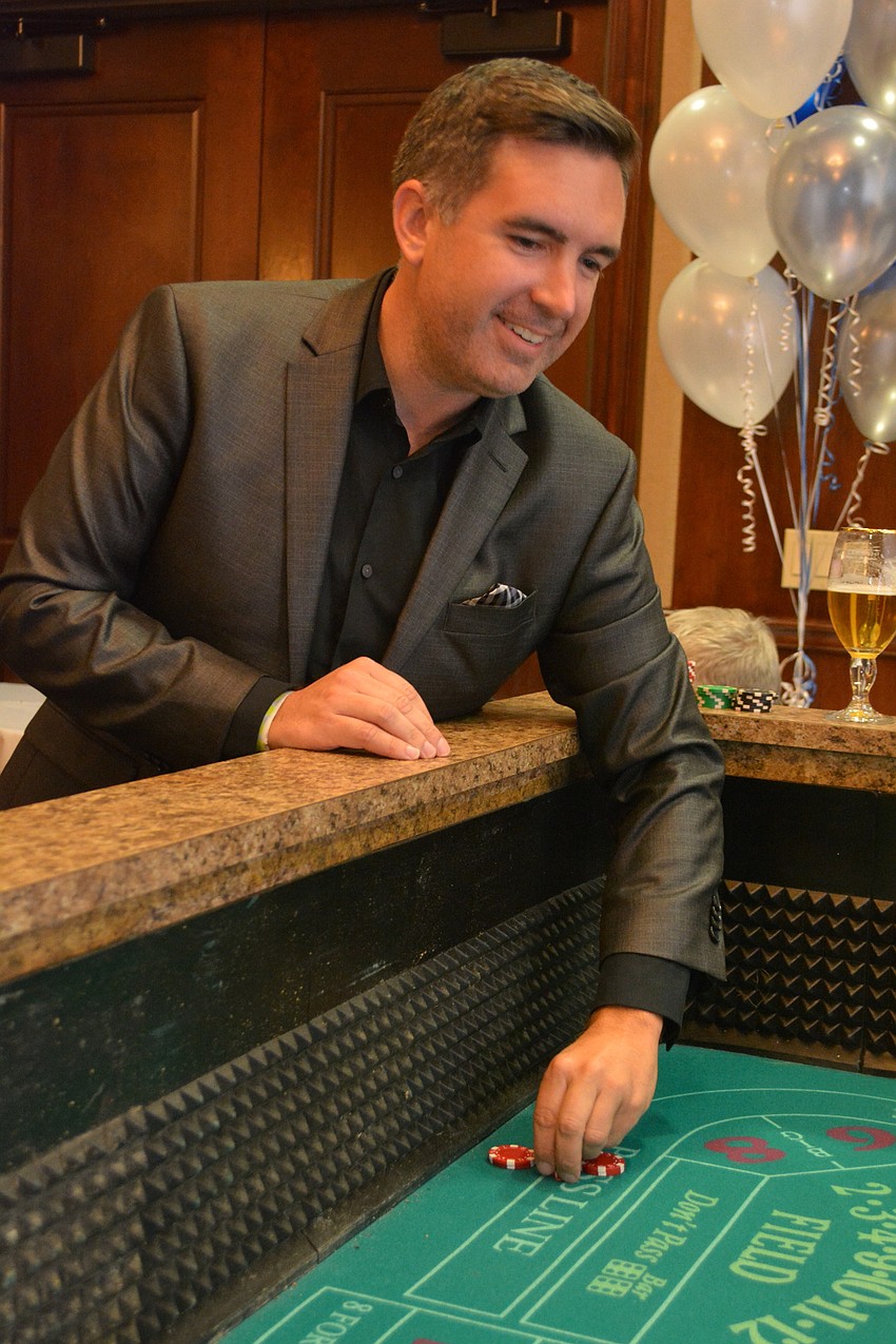Joel Rasho enjoys his favorite casino game, craps, at the event.