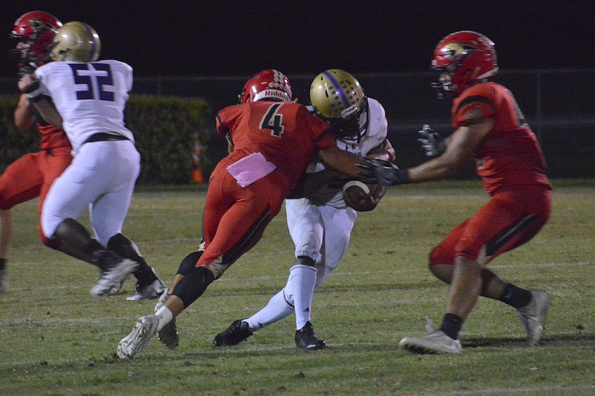 Cardinal Mooney senior safety Sam Koscho (4) lays a big hit on Booker senior Antrone Thomas.