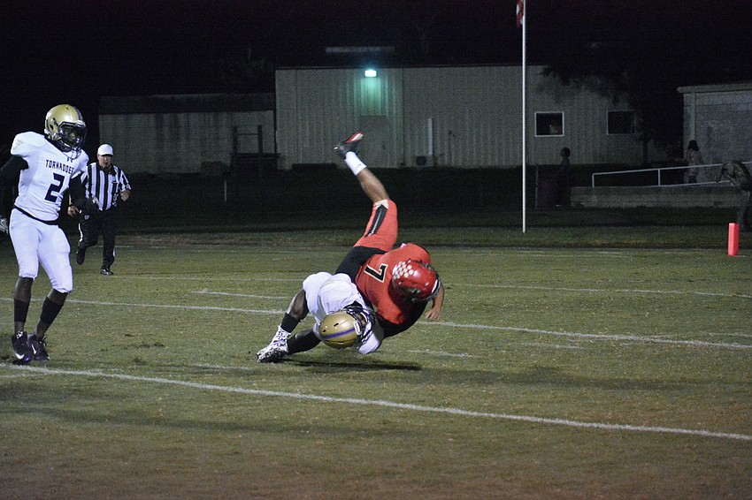 Booker senior Darrion Marshall suplexes Mooney running back Isaac Green to the turf.