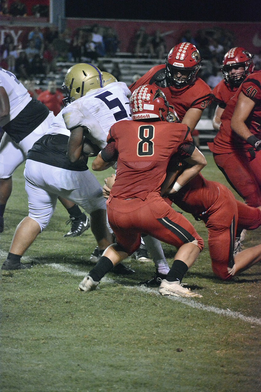 Booker senior running back Antrone Thomas (5) bruises his way through the Cougars defense.