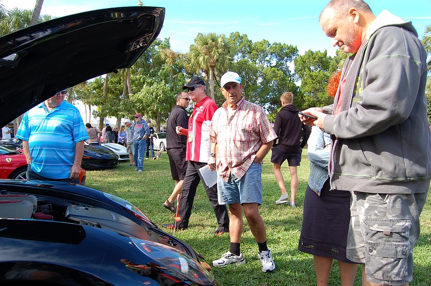 A black Ferrari arrived after the show had begun, attracting a crowd.