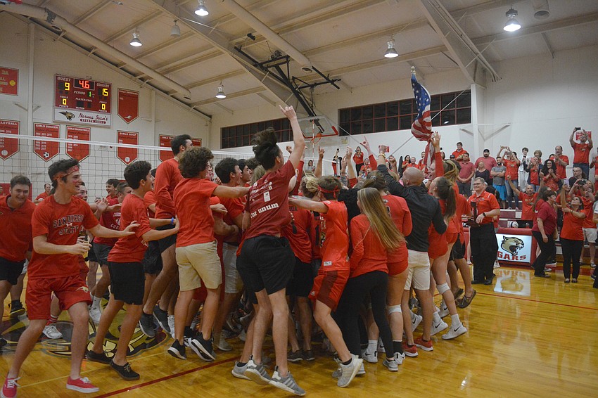 The Cardinal Mooney crowd rushes the court after the win.
