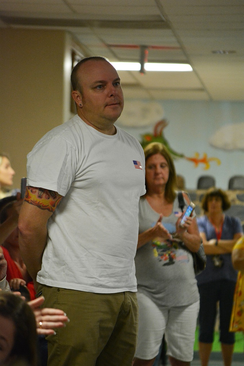 Lt. Chris Campbell, a firefighter with the City of Bradenton Fire Department, stands to be recognized, along with other veterans and first responders.