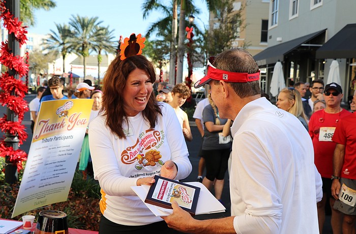 Chief philanthropy officer, Denise Pope presenting the award to overall male winner Orlando Cicilioni at the event last year.