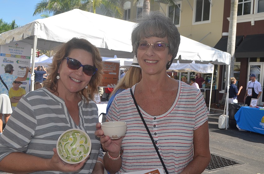 Lakewood Ranch's Marianne Lopata and East County's Katherine Wingert take time out to make sure they get the perfect ceramic bowl to take home.