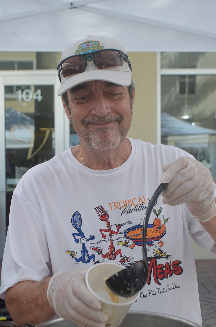 Sable Harbor's Joe Angers says he just likes to volunteer for a good cause as he serves soup from O'bricks Irish Pub & Martini Bar.