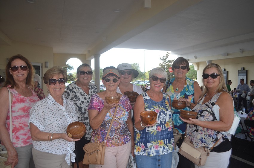 University Park's Kris Pizzi and Riverstrand's Noelle Connor , Nancy Sacarakis, Tina Kashdin, Julie Abraham, Marcia Kelly, Sue Boyer and Joanna Clark use Empty Bowls as a way to catch up with each other.