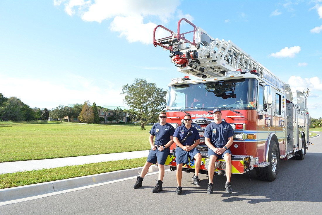 East Manatee Fire Rescue firefighter Ben Carpenter, engineer Jacob Lilly and firefighter Chad Hoeksema work at Station 4, the station closest to the new site, pictured in background.