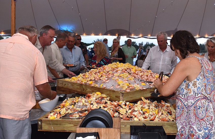Guests fill their plates with stone crab and shrimp.