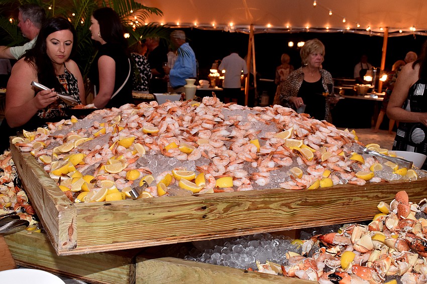 Piles of shrimp and stone crab sit in the center of the event tent for guests to dine on.