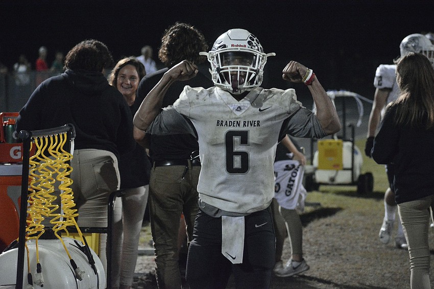 Junior running back Brian Battie flexes after his 96-yard touchdown sprint.