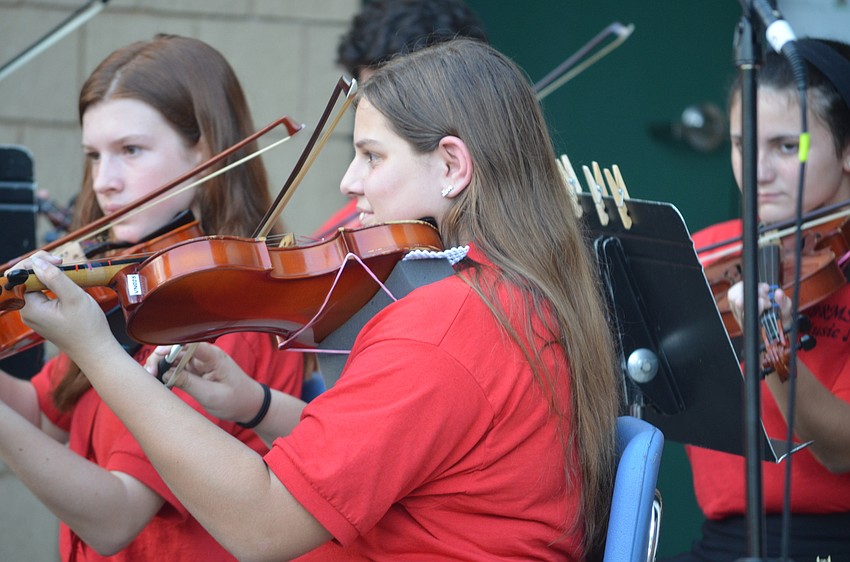 Alyssa Theodore, an eighth-grade violinist, plays with the orchestra during the 18th annual ceremony.