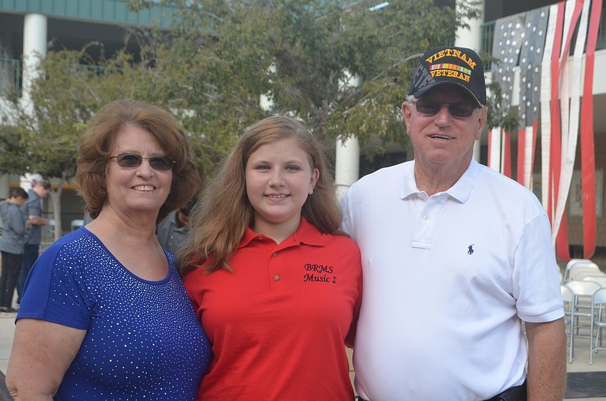 Carlene Koons and Sophia Swim surprised William Koons by having his name painted on the mosaic tile honoring veterans that will hang in the school forever.