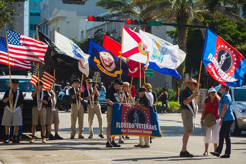 Members of Florida Veterans for Common Sense wave their flags.
