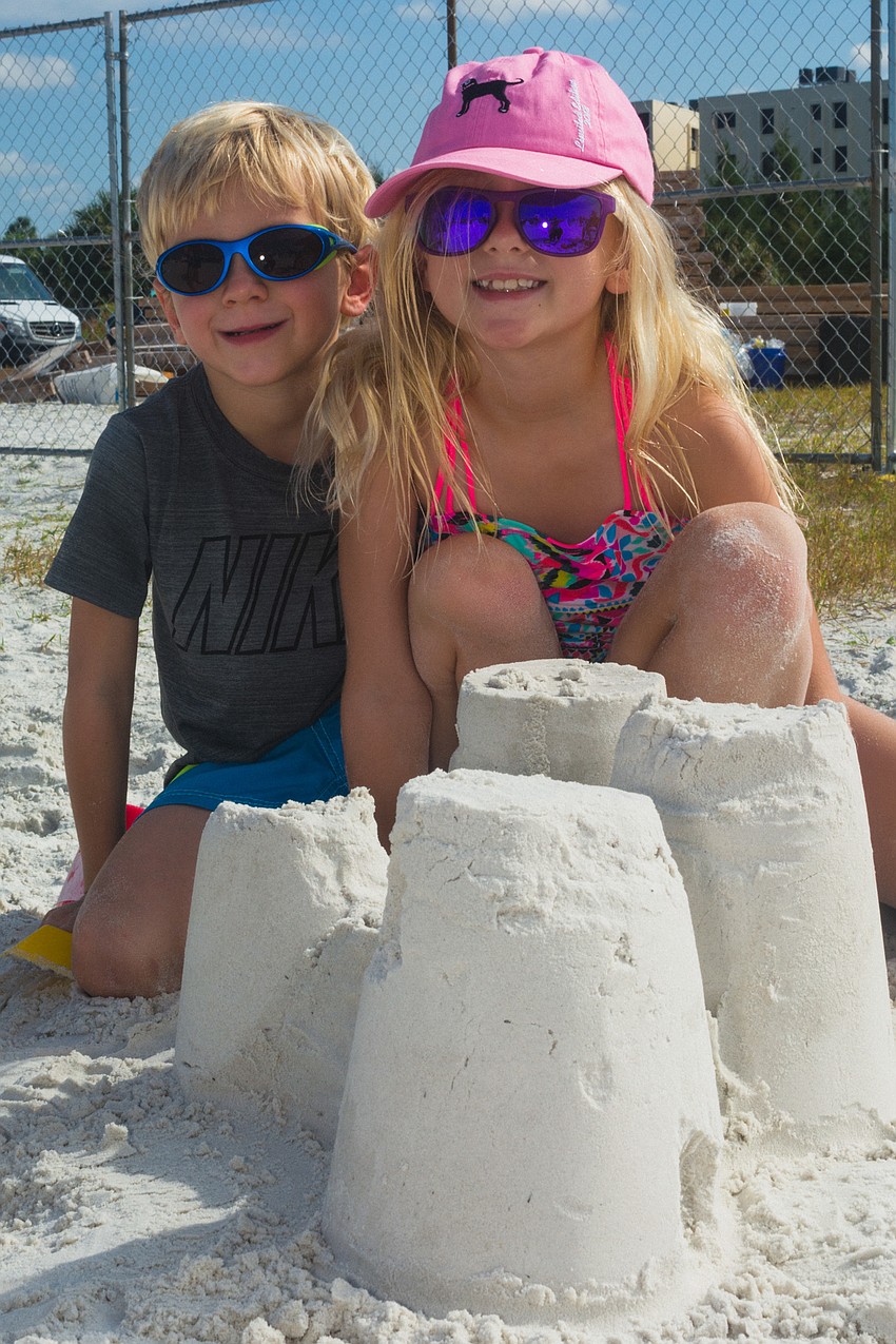 Kailin and Callum  Greenwood try their hand at building sand sculptures.